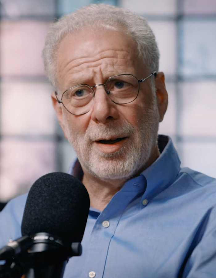 A man with glasses and a beard speaking into a microphone about a Mediterranean diet study.