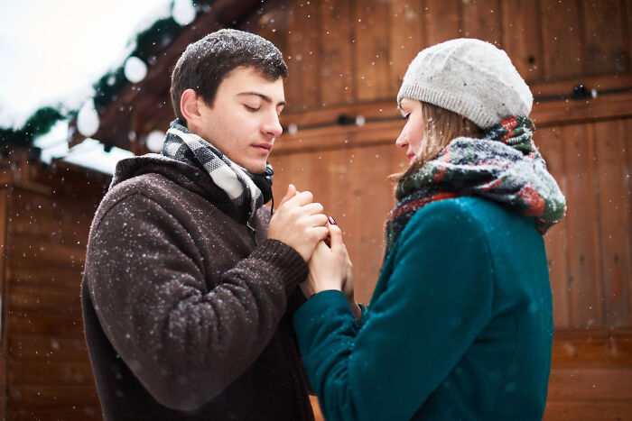 Couple holding hands outside in cold weather depicting relationship challenges