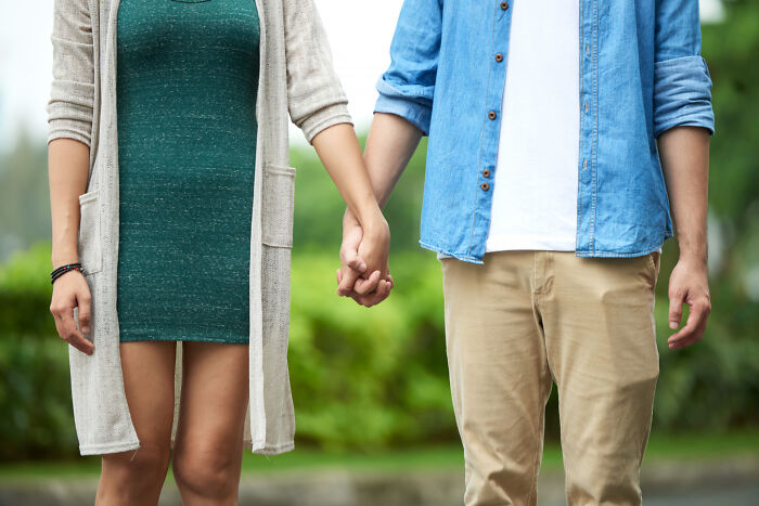 Couple holding hands outdoors representing toxic traits in relationships