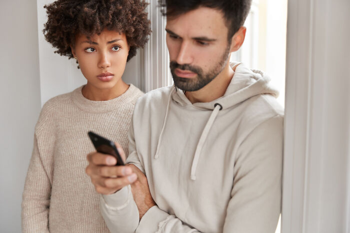 Couple arguing as man ignores woman showing toxic relationship traits