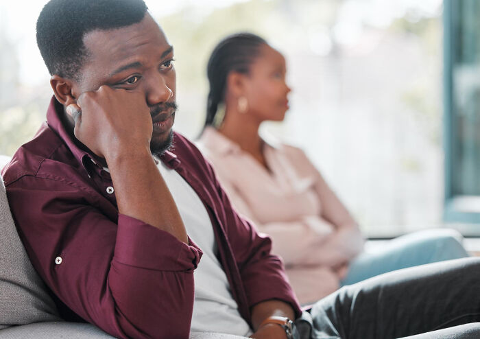 Man looking distant during couple's conflict showing toxic boyfriend traits