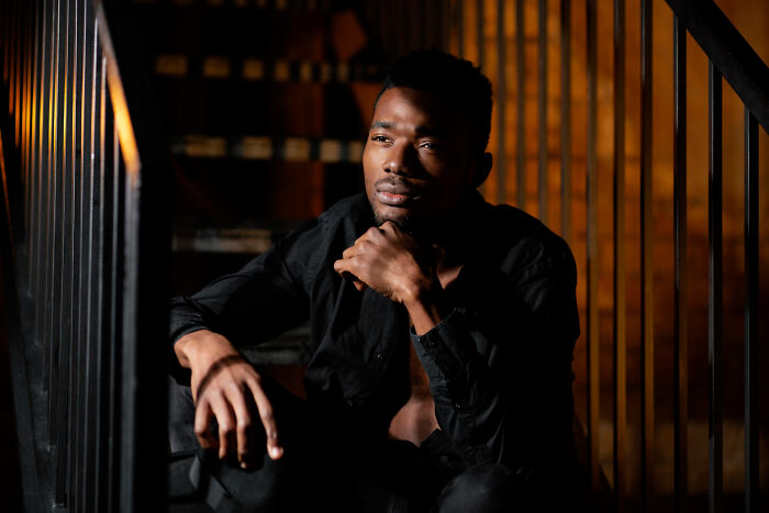 Man in thoughtful pose sitting on stairs contemplating toxic traits in love life