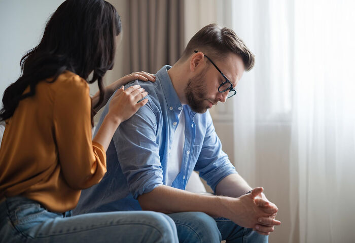 Woman comforting upset man showing toxic traits in relationship