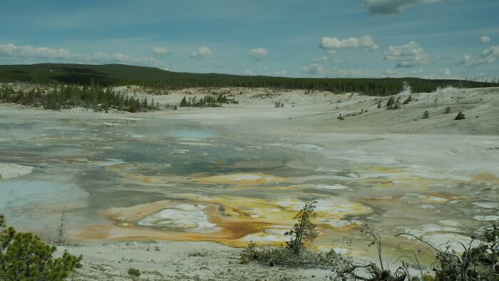 A scenic view of a geothermal basin in Yellowstone, far removed from political scandals