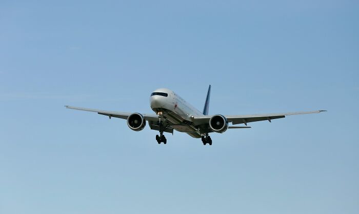 Commercial airplane in flight, representing passenger travel and the journey of a plane seatmate