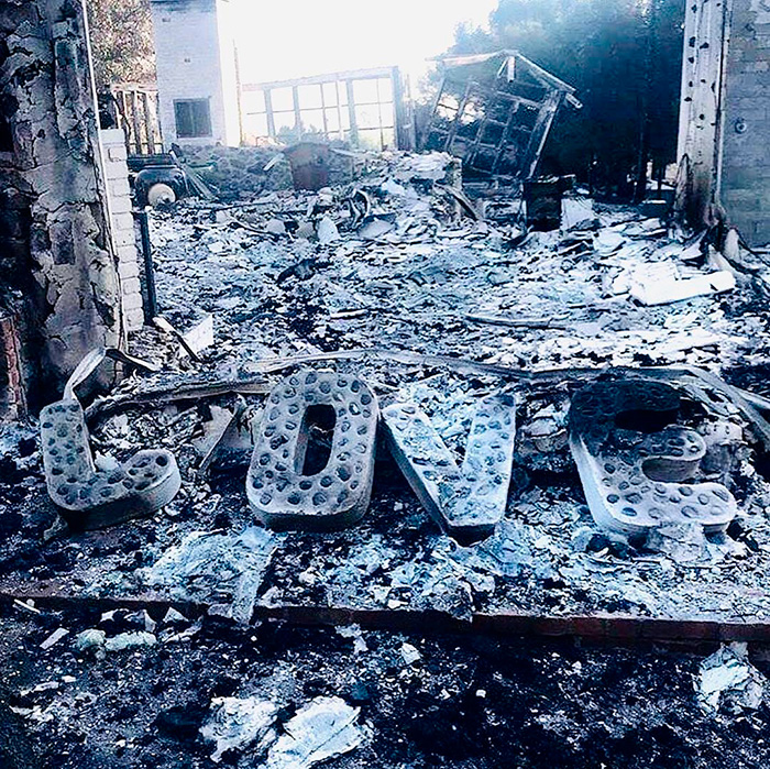 Miley Cyrus’s Malibu home devastated by wildfires, with the word “LOVE” still standing amidst the rubble.