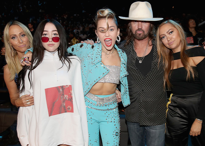 Miley Cyrus with her family: mom Tish, sister Noah, dad Billy Ray, and sister Brandi