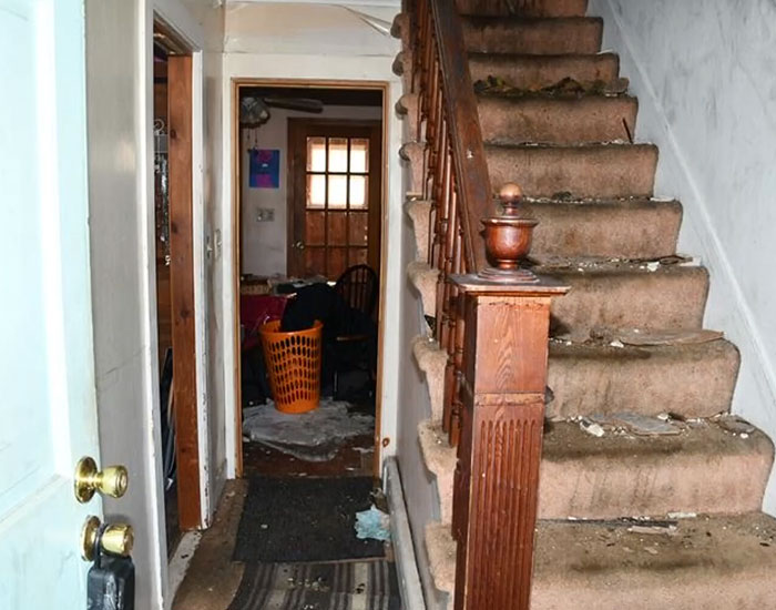 A worn staircase and messy hallway in the house where a stepson was held captive. A worn staircase and messy hallway in the house where a stepson was held captive.