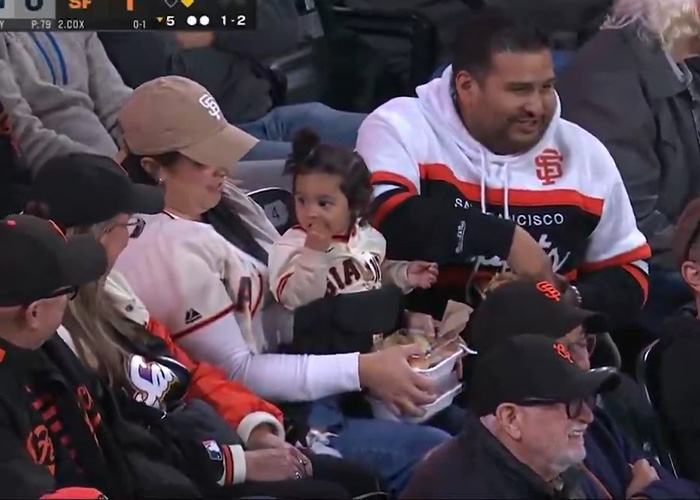 Mom of the year sharing food with child at Giants game with spectators