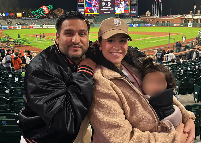 Family enjoying San Francisco Giants baseball game with toddler