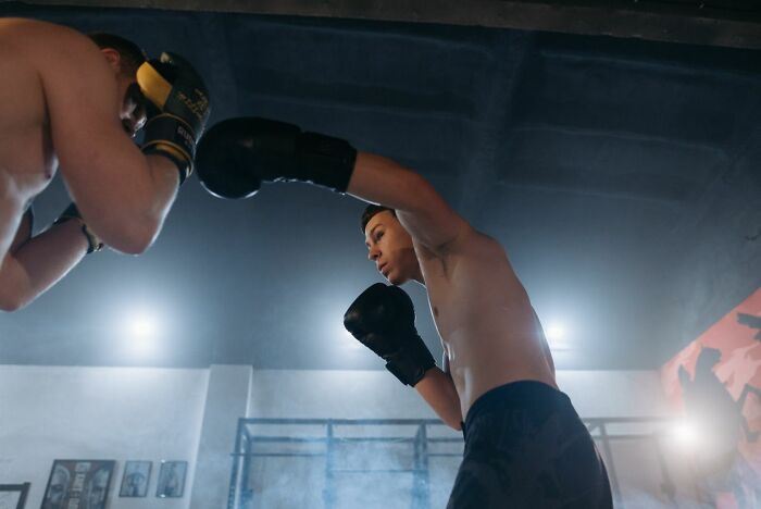 Two boxers in a ring; a legal excuse could involve a medical condition that prevents fighting.
