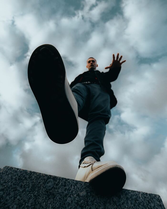 A low-angle shot of a man lifting his foot, suggesting a legal excuse for an action or accident.