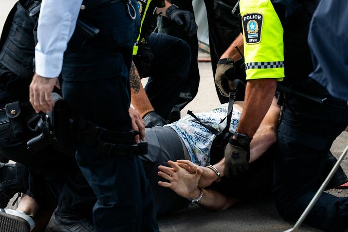 Police officers arresting a man, highlighting the need for credible legal excuses.