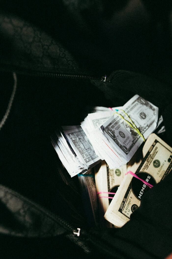 Bundles of cash, hinting at potential legal excuses related to money.