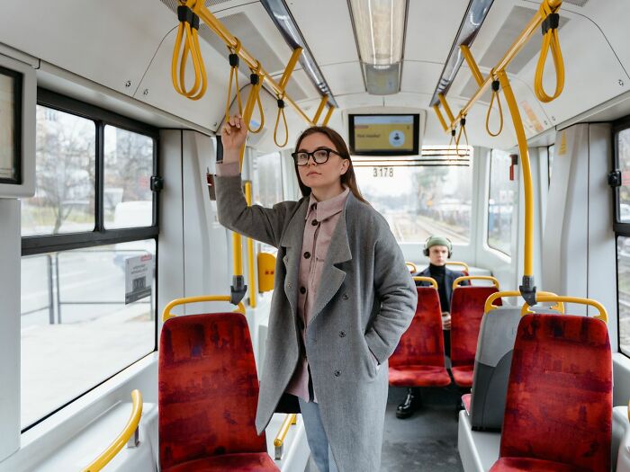 A woman in glasses on a bus, reflecting on legal excuses.