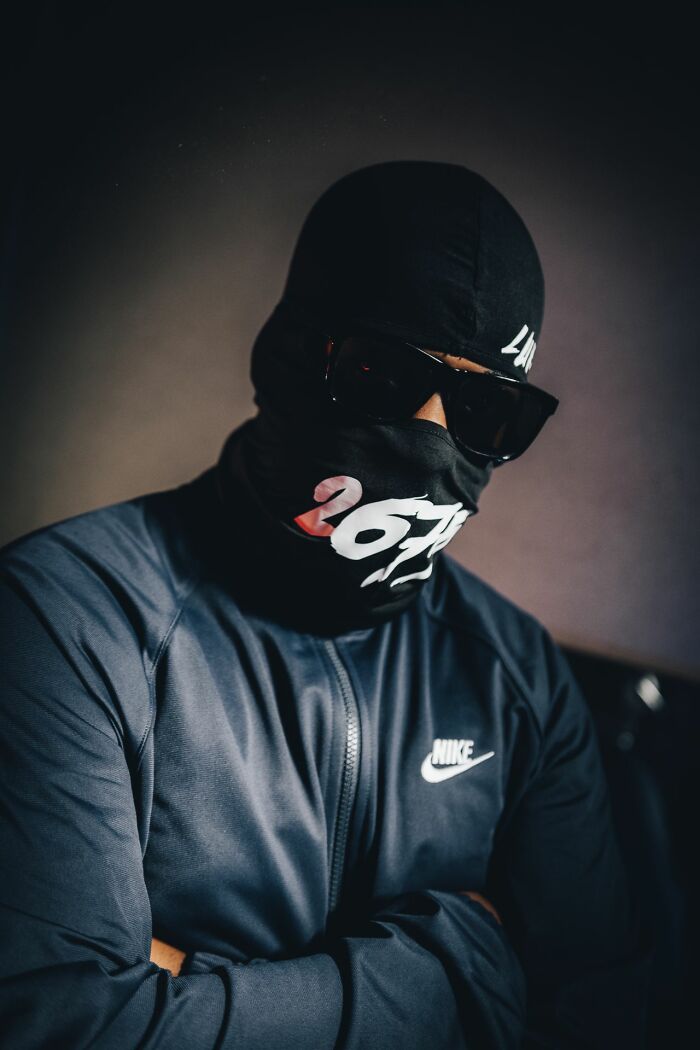 A person in a black ski mask, sunglasses, and a Nike jacket. This image illustrates legal excuses.