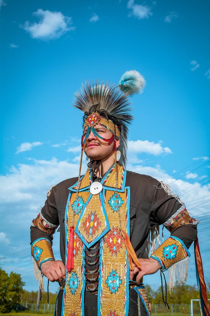 A man in traditional Native American attire, presenting a powerful image, unrelated to legal excuses.