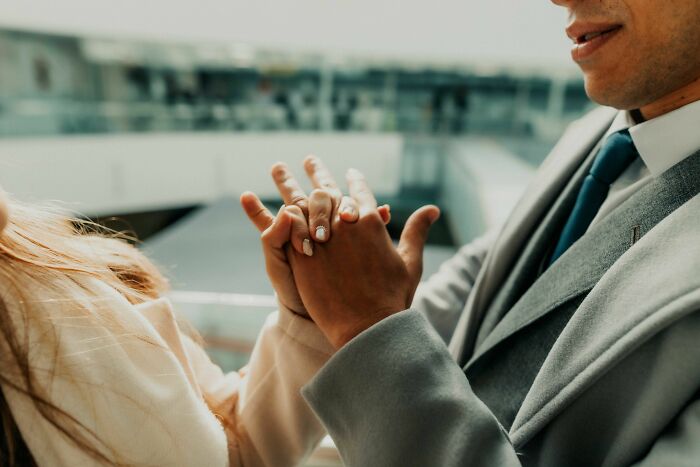 A couple holding hands, a symbol of dating and relationship changes during a midlife crisis.