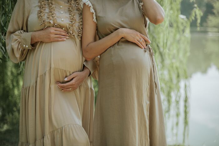 Two pregnant women, symbolizing new beginnings after a midlife crisis.
