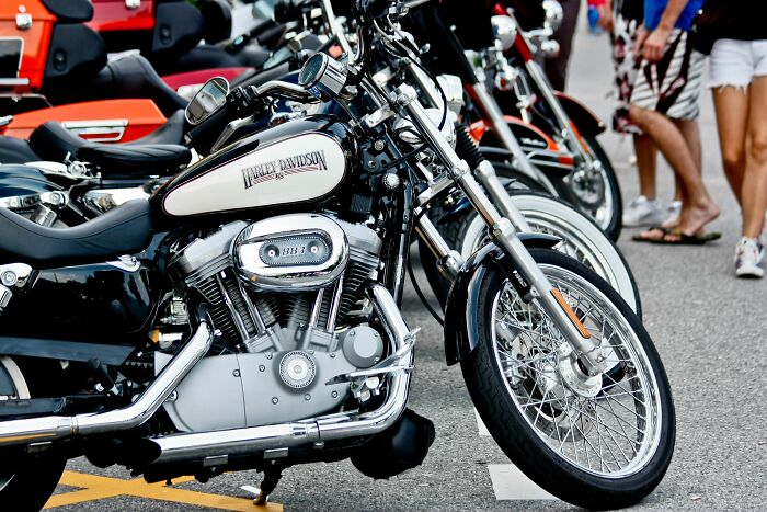 Row of parked Harley Davidson motorcycles, representing adventurous changes during a midlife crisis.