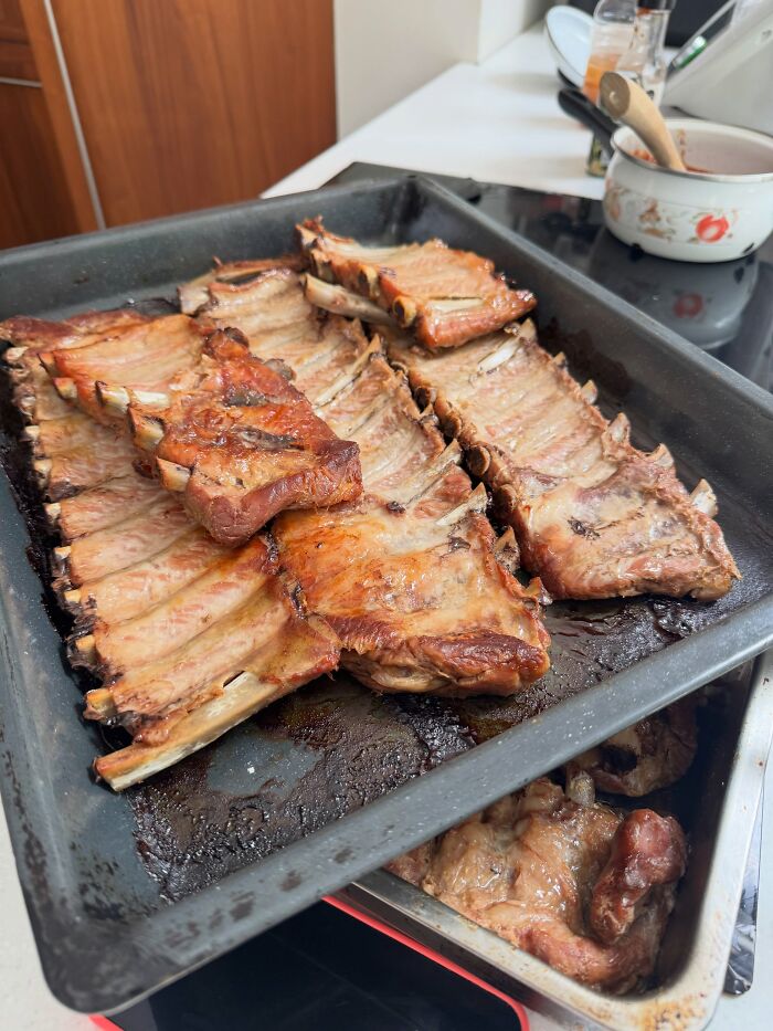 A tray of cooked ribs, part of a meat-only diet, showcasing the woman's meal choices. A tray of cooked ribs, part of a meat-only diet, showcasing the woman's meal choices.