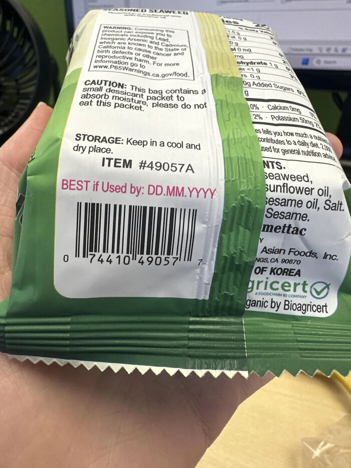 Hilarious photos: A hand holding a bag of seasoned seaweed with the expiration date and barcode visible.