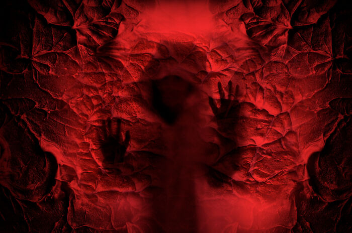 A haunting red image depicting a silhouette and hands, symbolizing eerie places and ancient entrances. A haunting red image depicting a silhouette and hands, symbolizing eerie places and ancient entrances.