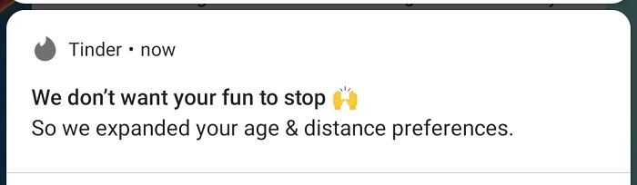A Tinder notification stating they expanded user preferences without consent, demonstrating terrible product design.