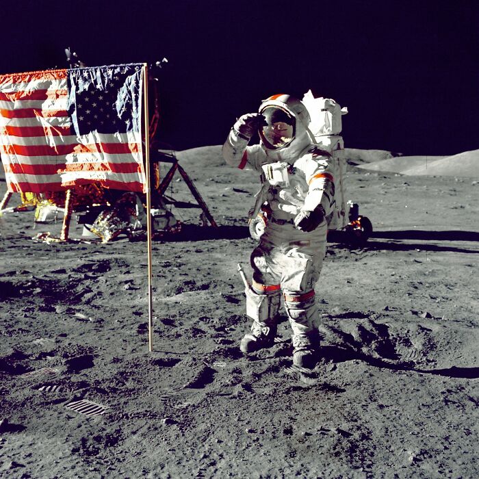 An astronaut saluting next to an American flag on the moon, symbolizing the ridiculous things people said.