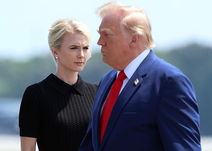 Trump aide Natalie Harp stands near Donald Trump outdoors