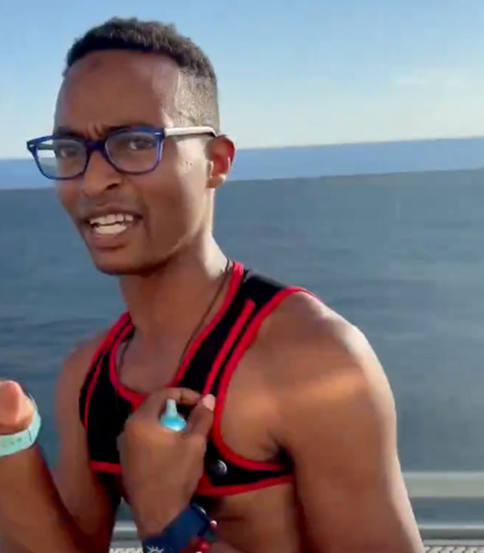 A man wearing glasses and a fitness tracker, looking surprised, against a bright blue ocean background, highlighting cruise ticket scammer. A man wearing glasses and a fitness tracker, looking surprised, against a bright blue ocean background, highlighting cruise ticket scammer.