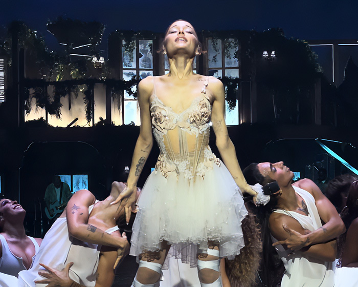 Ariana Grande performing on stage, eliciting worry and concern from fans regarding her appearance.