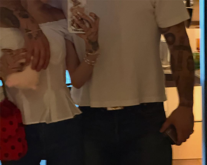 Ariana Grande with a person, showing a concerning detail that spurs worry.