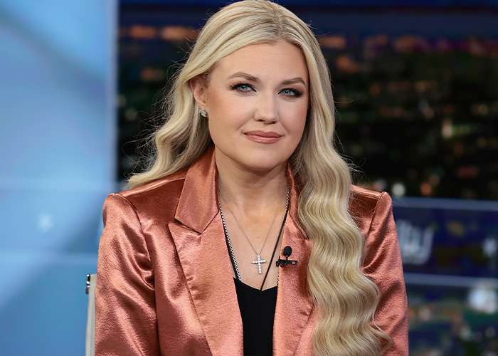 A portrait of conservative commentator Erika Kirk wearing a metallic blazer, a key focus in subliminal messaging theories A portrait of conservative commentator Erika Kirk wearing a metallic blazer, a key focus in subliminal messaging theories