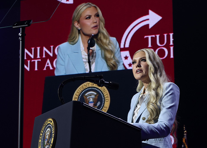 Erika Kirk speaking behind a presidential podium at a Turning Point Action event Erika Kirk speaking behind a presidential podium at a Turning Point Action event