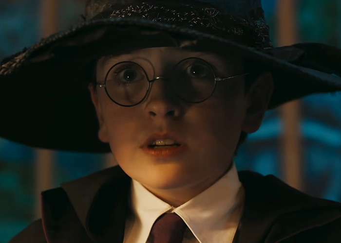 A young boy resembling Harry Potter, with round glasses and a wizard hat, looking surprised, sparking fan debate. A young boy resembling Harry Potter, with round glasses and a wizard hat, looking surprised, sparking fan debate.