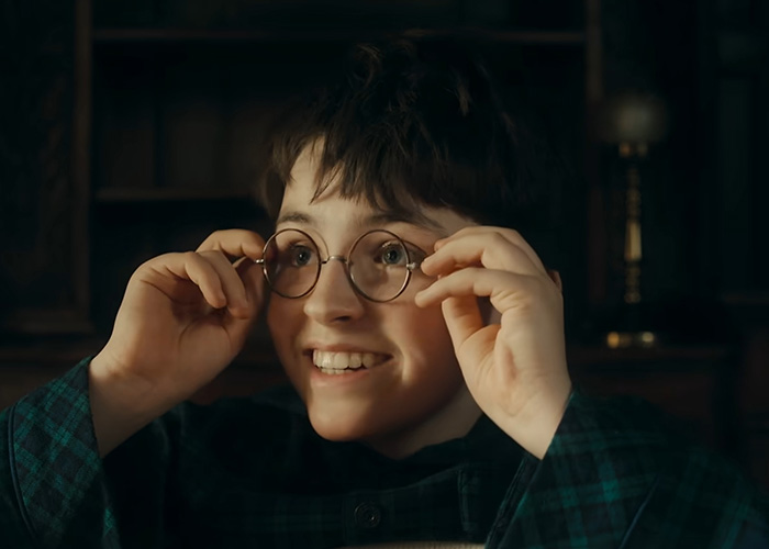 A young Harry Potter actor, Daniel Radcliffe, looking happy and excited while adjusting his round glasses. Harry Potter backlash. A young Harry Potter actor, Daniel Radcliffe, looking happy and excited while adjusting his round glasses. Harry Potter backlash.