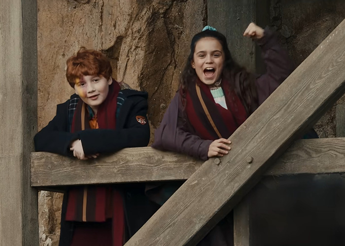 Two young fans, a boy and a girl, cheering enthusiastically, fueling the Harry Potter backlash debate. Two young fans, a boy and a girl, cheering enthusiastically, fueling the Harry Potter backlash debate.