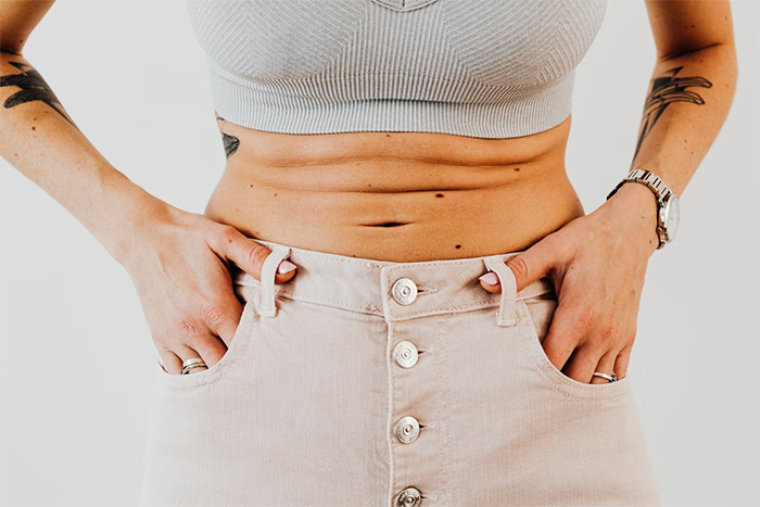 Woman with stomach rolls wearing a bikini top, dealing with unsolicited bikini advice and body-shaming from a friend. Woman with stomach rolls wearing a bikini top, dealing with unsolicited bikini advice and body-shaming from a friend.