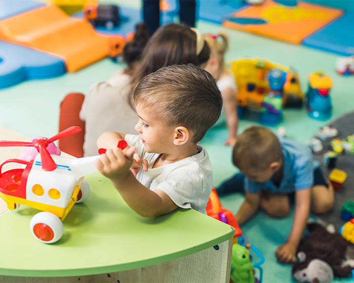 Children playing with toys in a nursery setting, central to the unexpected debate after a dad's complaint went viral.