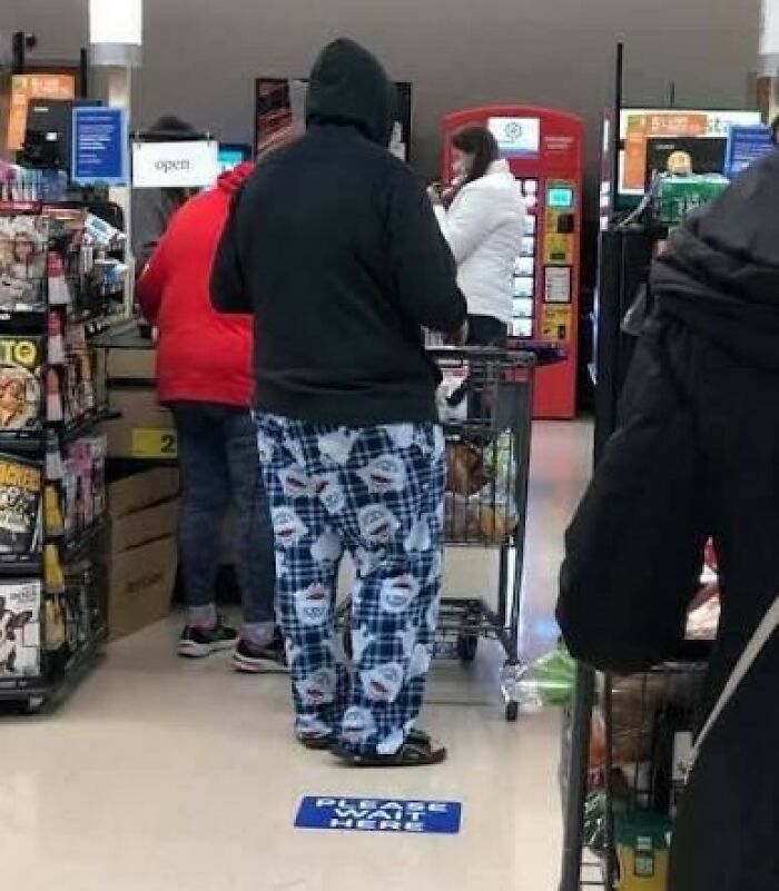 Man in patterned pajamas and hoodie in a grocery store, an action people judge them for.