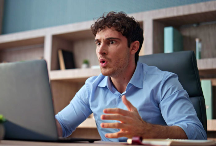 An employee looking shocked at his laptop, six years remote, HR approved home office for the employee at HQ. An employee looking shocked at his laptop, six years remote, HR approved home office for the employee at HQ.
