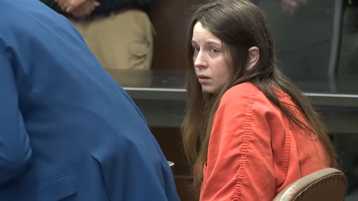 Ohio House of Horrors mom of 16 during a court appearance sitting in an orange jumpsuit.