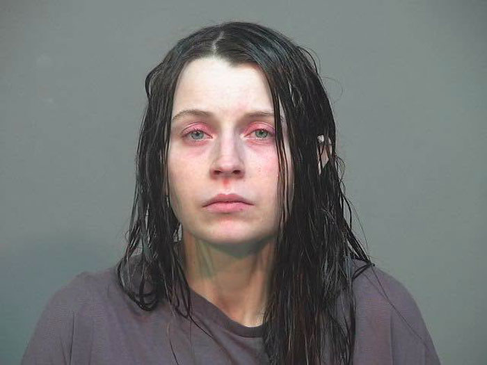 Mugshot of the Ohio House of Horrors mom of 16 with messy hair and red-rimmed eyes.