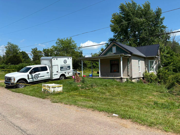 A crime scene unit truck parked outside the Ohio House of Horrors home.