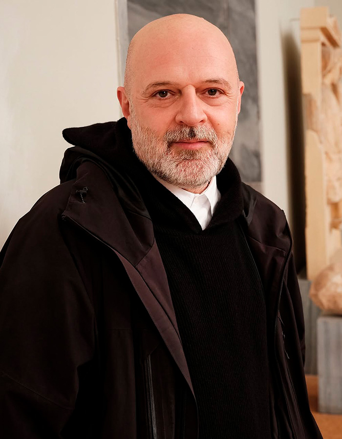 Portrait of a bald man with beard in black jacket indoors Portrait of a bald man with beard in black jacket indoors