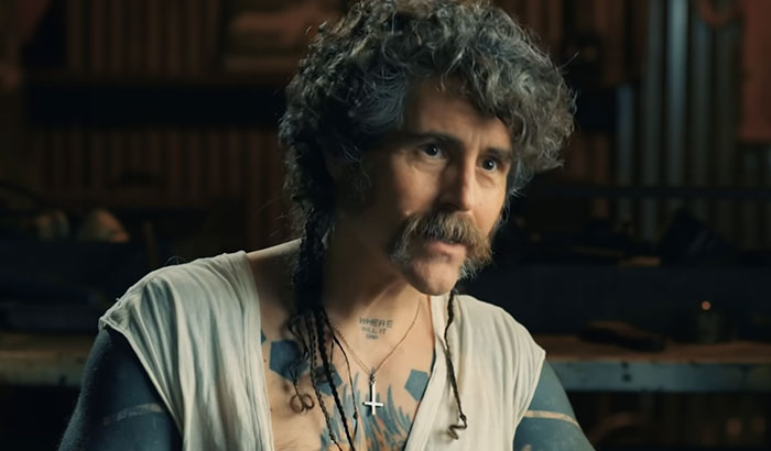 A man with tattoos and a mustache representing times celebrities met people