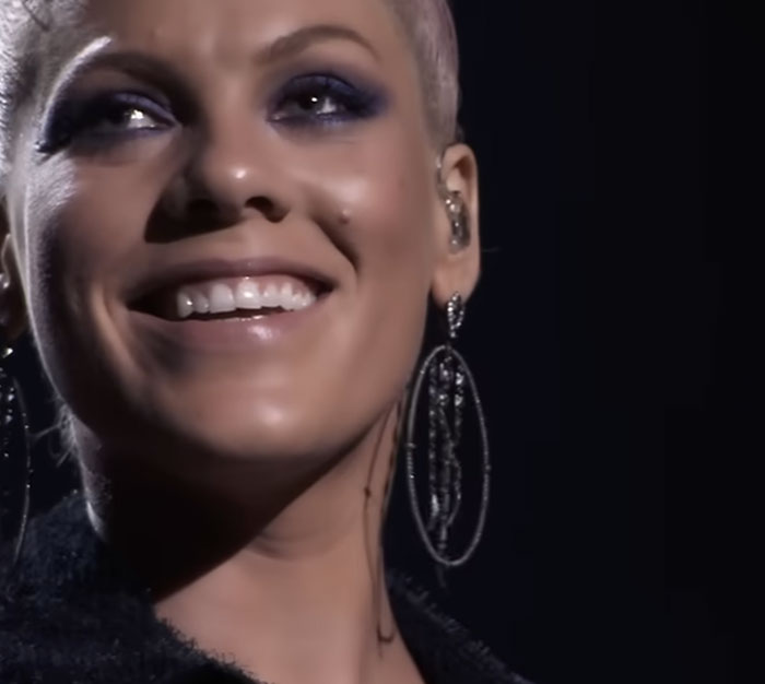 Singer Pink smiling, highlighting times celebrities visited ordinary people