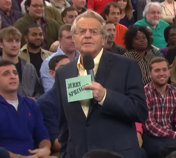 TV host Jerry Springer speaking to a crowd, one of many celebrities who surprised people.