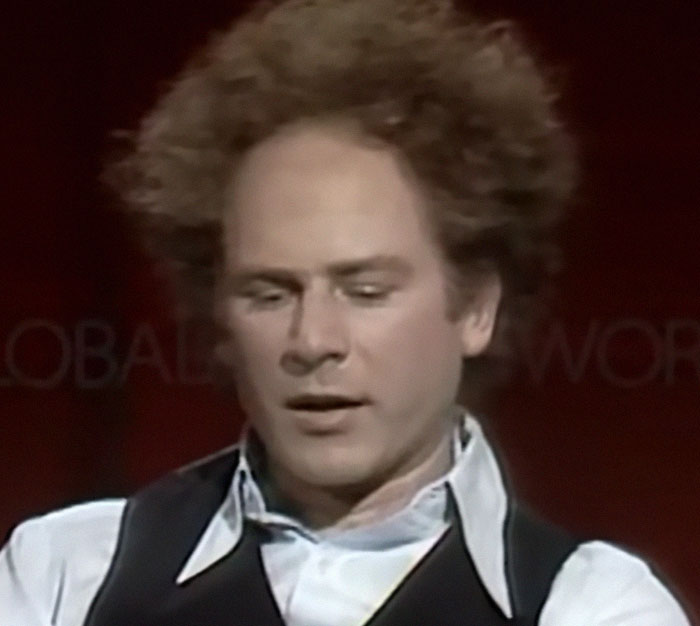 Singer Art Garfunkel looking down thoughtfully, a famous celebrity known for memorable interactions.